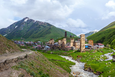 Panoramic view of buildings and mountains against sky