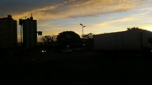 Buildings in city at sunset