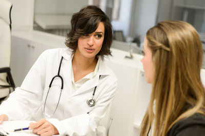 Female doctor discussing with patient at hospital