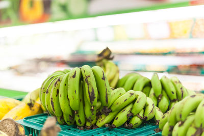 Close-up of half ripe banana for sale at market stall