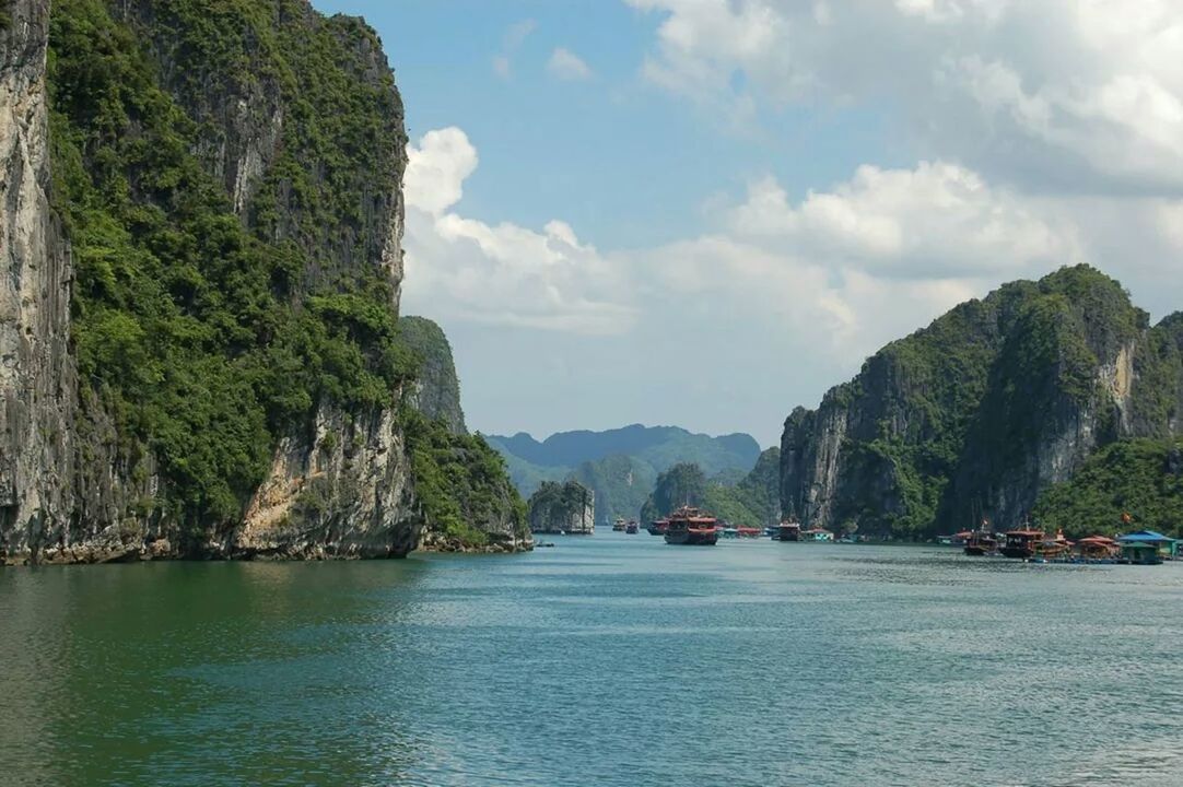 mountain, water, sky, waterfront, transportation, scenics, tranquil scene, nautical vessel, tranquility, beauty in nature, sea, mode of transport, nature, boat, mountain range, rock formation, cloud - sky, tree, cloud, river