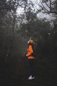 Rear view of woman running in forest