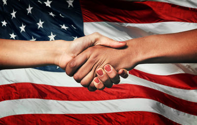 Low section of man holding american flag