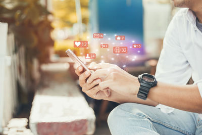 Midsection of man holding text at home