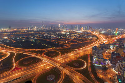 High angle view of illuminated city buildings at night