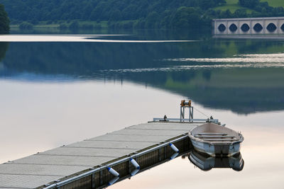 Boat tied up at pier at the ladybower reservoir in the peak district