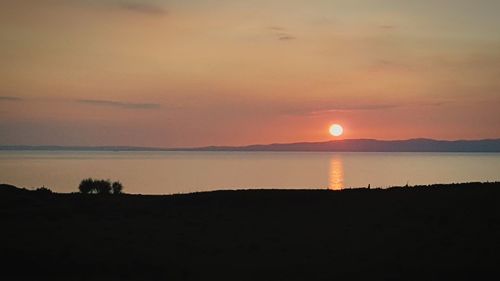 Scenic view of sea against romantic sky at sunset