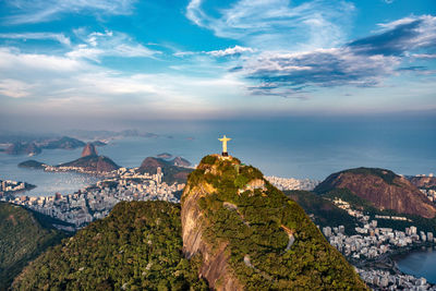 Christ the redeemer on mountain against sky