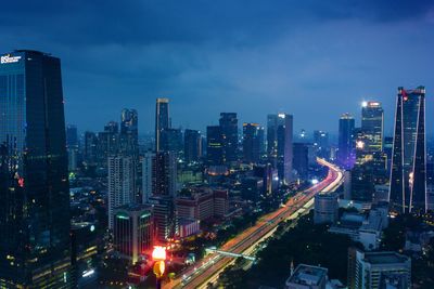 High angle view of city lit up at night