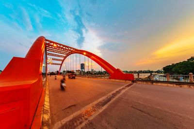 View of bridge over road against sky during sunset