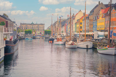 Nyhavn canal with boats and yachts near colorful houses  in copenhagen, denmark