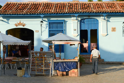 Rear view of man standing against built structure