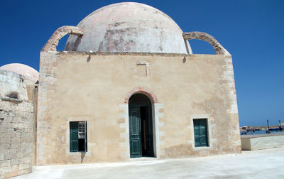 Exterior of historic building against clear blue sky