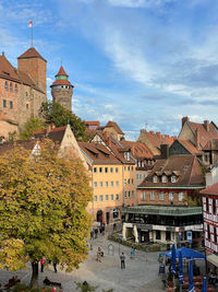 Buildings in town against sky