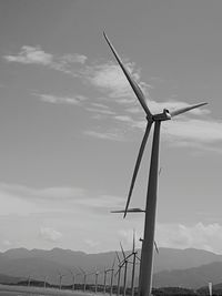 Low angle view of windmill against sky