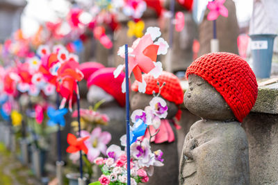 Close-up of statues by pinwheel toy in temple