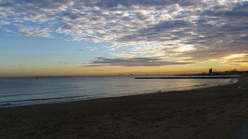 Scenic view of sea against cloudy sky