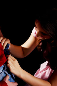 High angle view of woman unzipping man jeans