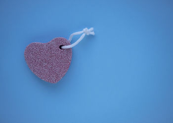 Close-up of heart shape over blue background