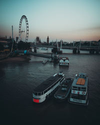 View of bridge over river in city at sunset