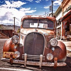 Abandoned car against sky