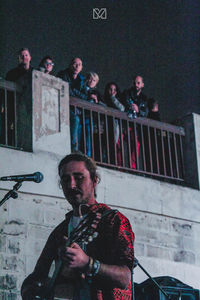 Portrait of people standing against wall