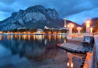 Reflection of illuminated buildings in lake at dusk