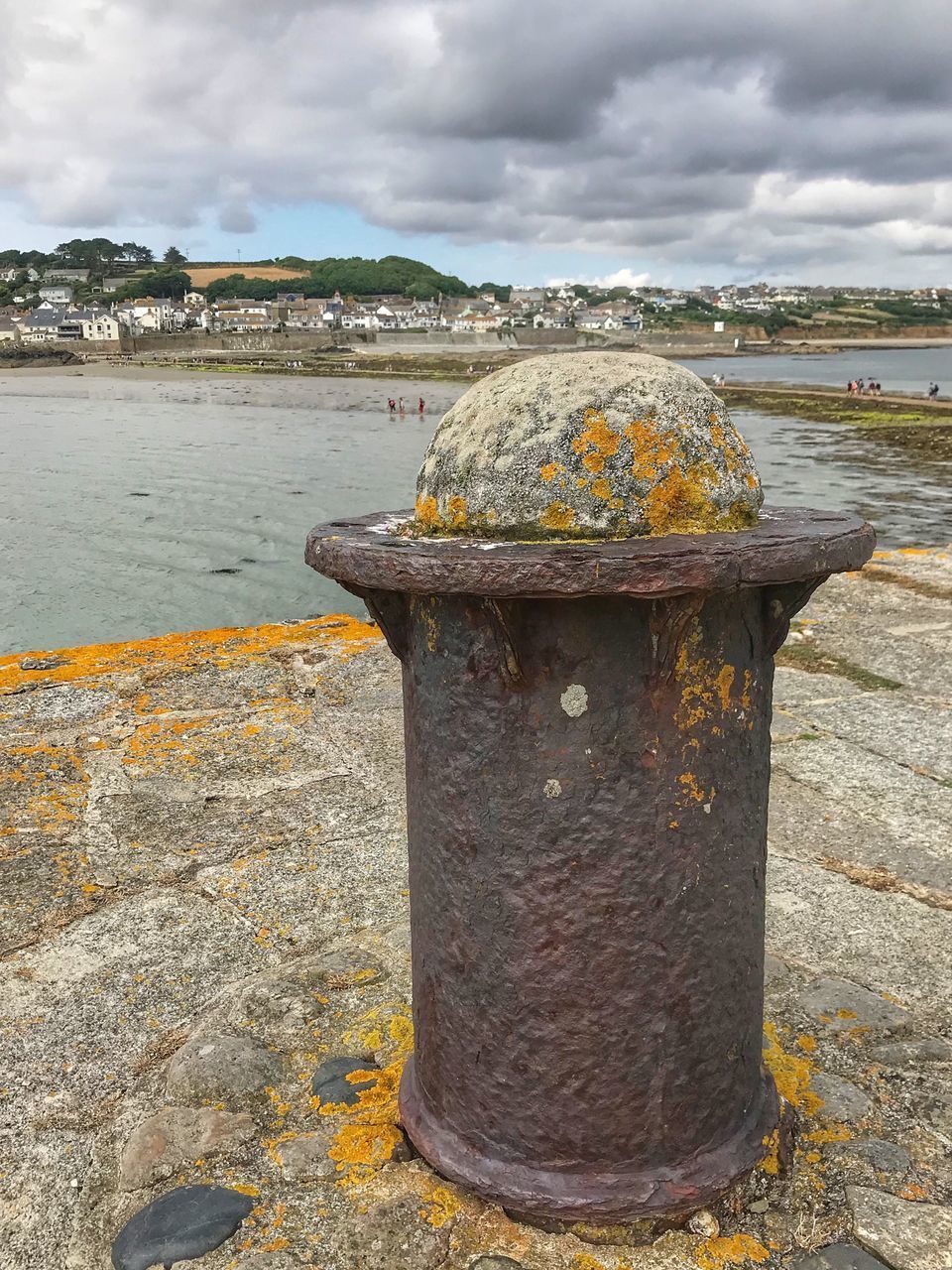 CLOSE-UP OF RUSTY METALLIC STRUCTURE ON BEACH