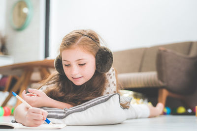 Girl writing on book