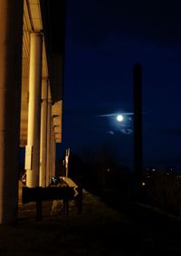 Illuminated lamp against sky at night