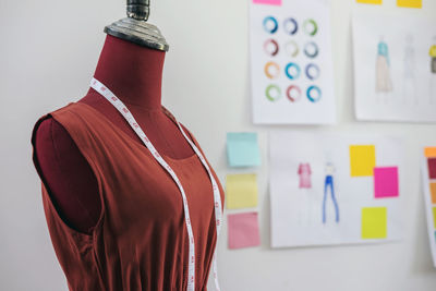 Close-up of mannequin against wall in clothing store