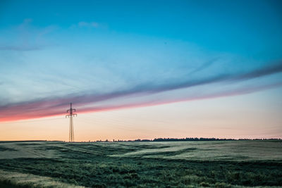 Scenic view of field against sky during sunset