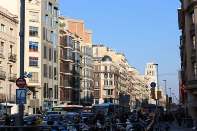 Cars on street against buildings in city