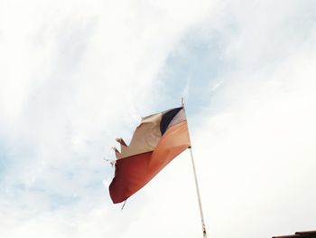 Low angle view of flag on pole against sky