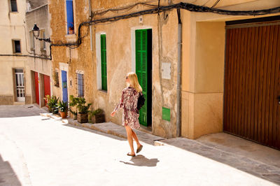 Woman walking by building