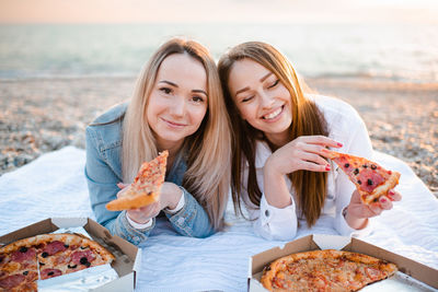 Portrait of smiling young woman having food
