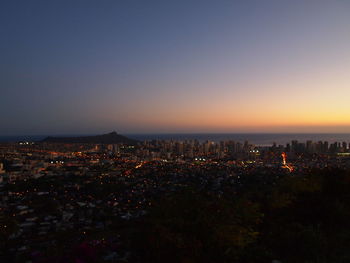 High angle view of illuminated buildings against sky at dusk