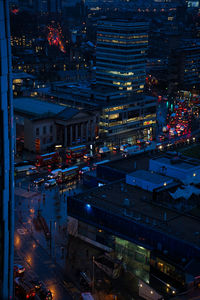 High angle view of illuminated buildings in city at night