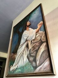 Low angle view of woman standing by window