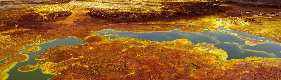 Panorama of surreal colors created by sulphur springs in the hottest place on earth, ethiopia.