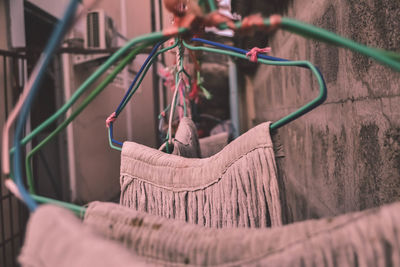 A mop hanging on the iron fence closely behind the house.