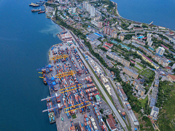 High angle view of buildings by sea against sky