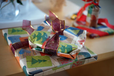 Close-up of christmas presents on table at home