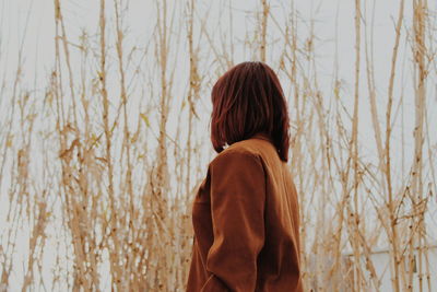 Rear view of girl standing on field