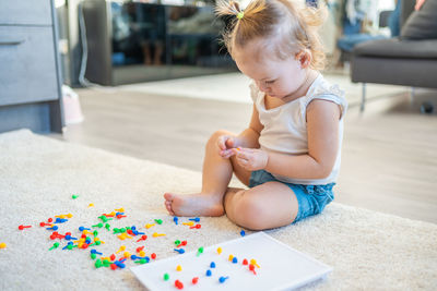 High angle view of cute girl playing with toy at home