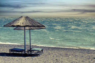 Scenic view of beach against sky during sunset