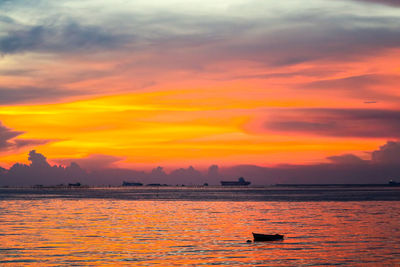 Scenic view of sea against orange sky