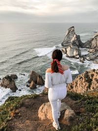 Rear view of woman looking at sea