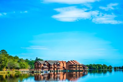 Lake by built structure against sky