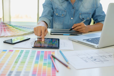 Close-up of man using laptop on table at home